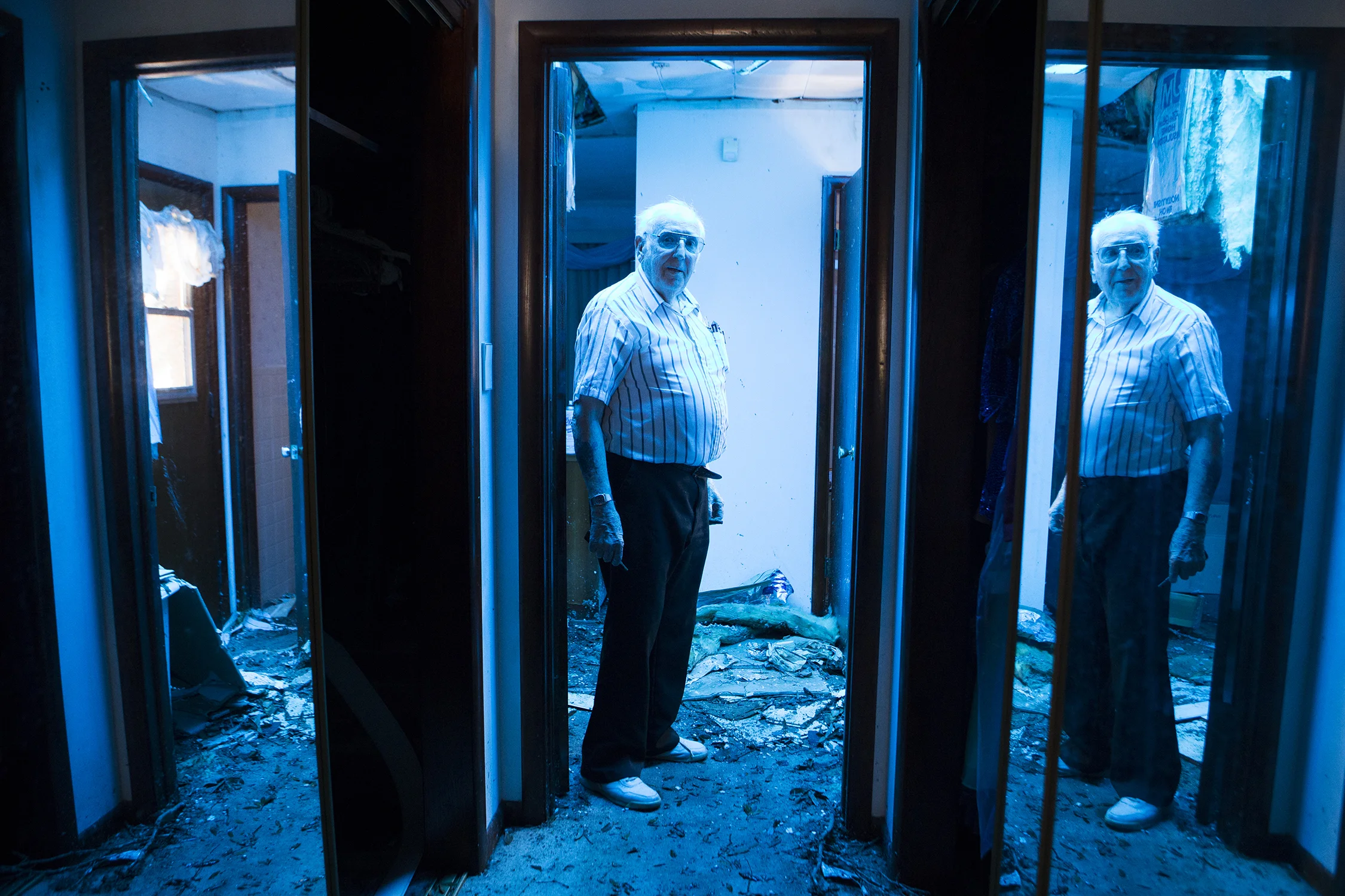  A.D Thomas's home glows blue due to a tarp roof in Parker, Florida on Thursday, October 18, 2018. Thomas and his daughter were trapped in the house for four days because of tree limbs and his fallen roof.  