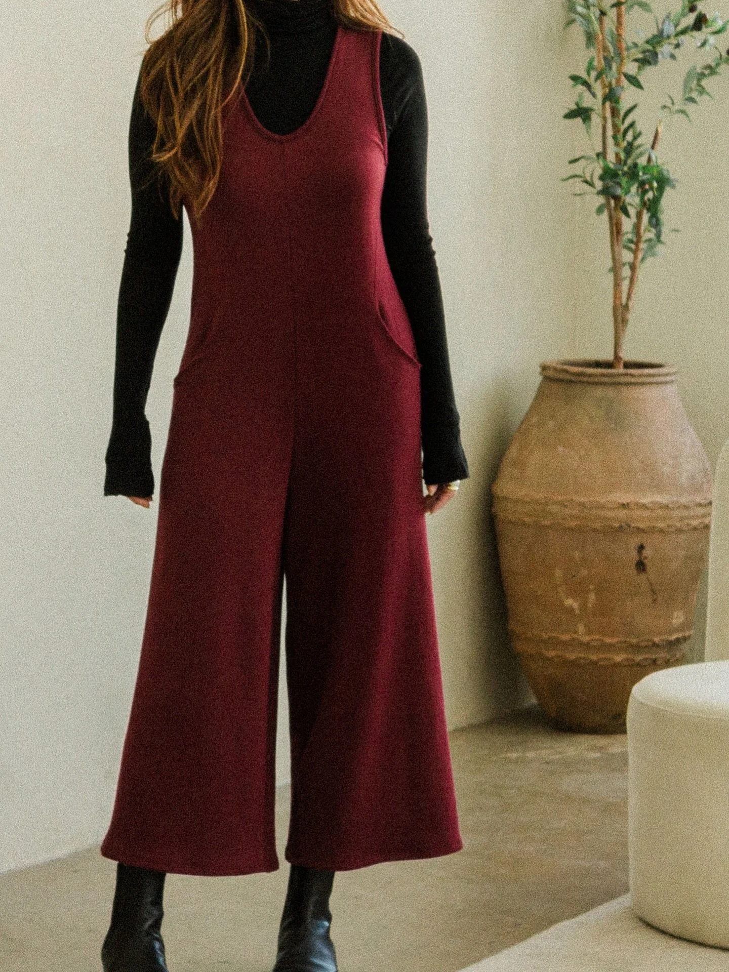 Camilla Jumpsuit in Cranberry. One of our fan favorite styles and can be worn in the cooler months layered with a top under. #corinnecollection #fw25 #aw25