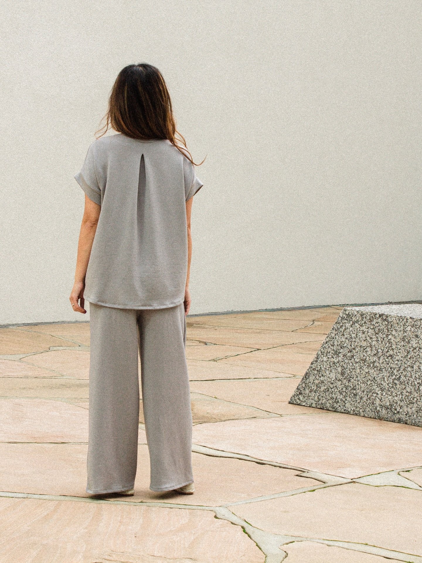 The delicate pleat detail on the Ella Back Pleat Top on Light Grey&mdash;paired with the Jojo Pleat Pant. #corinnecollection