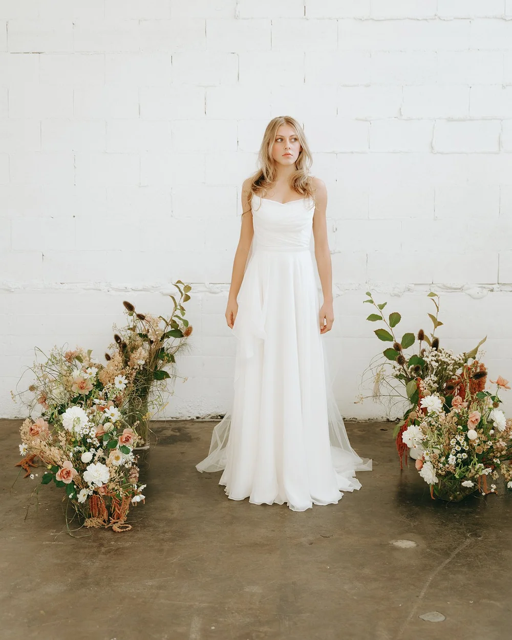 sachin and babi light blue dress Antoinette , A boho-inspired A-line gown with a chic V-neckline and  delicate lace straps. The sheer bodice is adorned with floral appliqus and  subtle beading, flowing into a soft chiffon skirt with