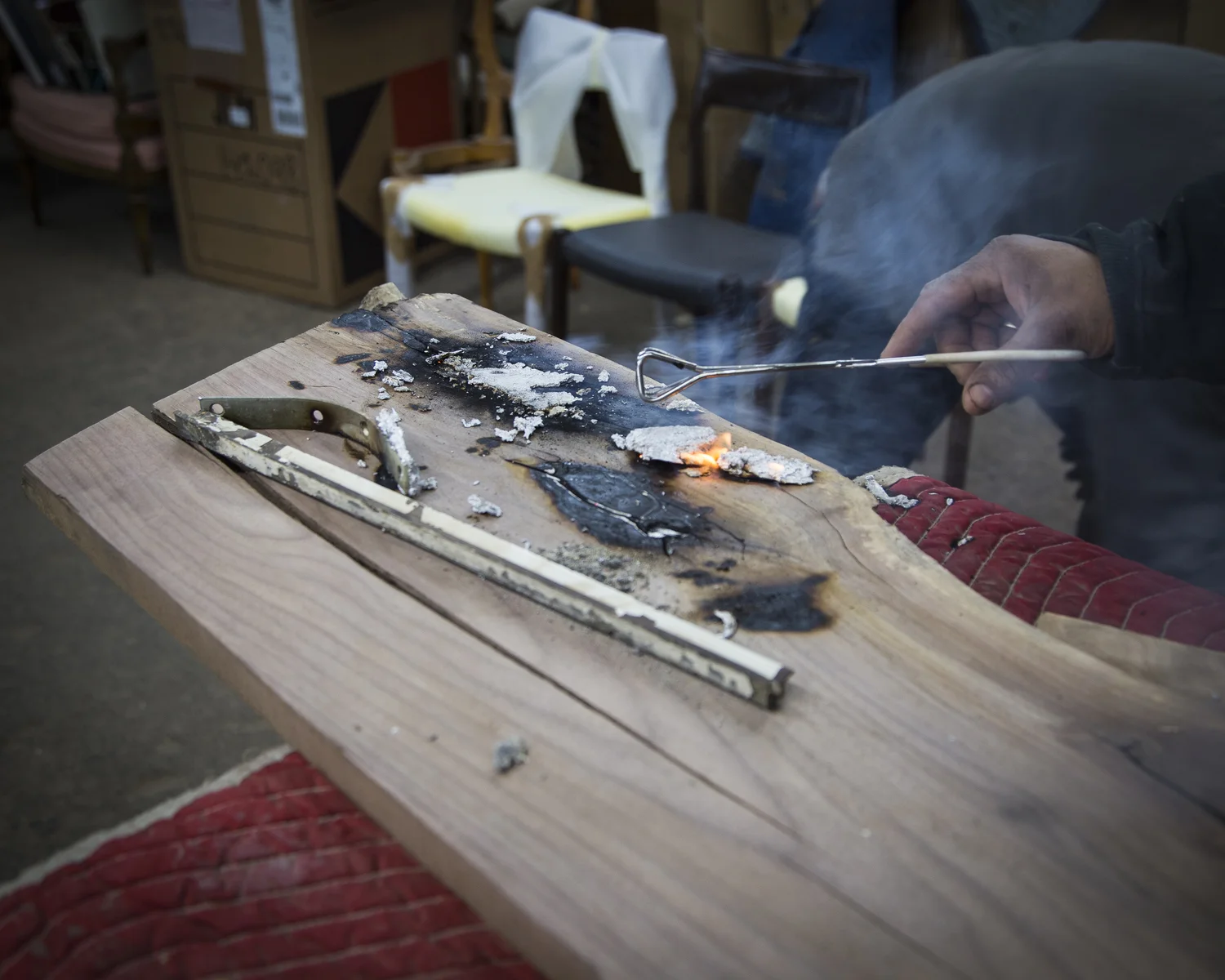 Step Two: Pour melted aluminum into cracks of wooden plank 