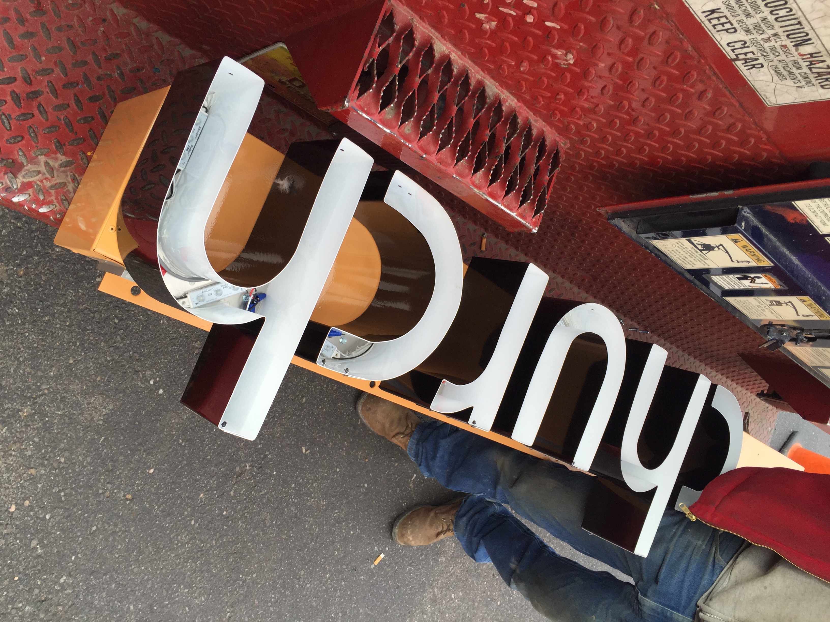A progression of the one of the signs being installed: 2 of 3