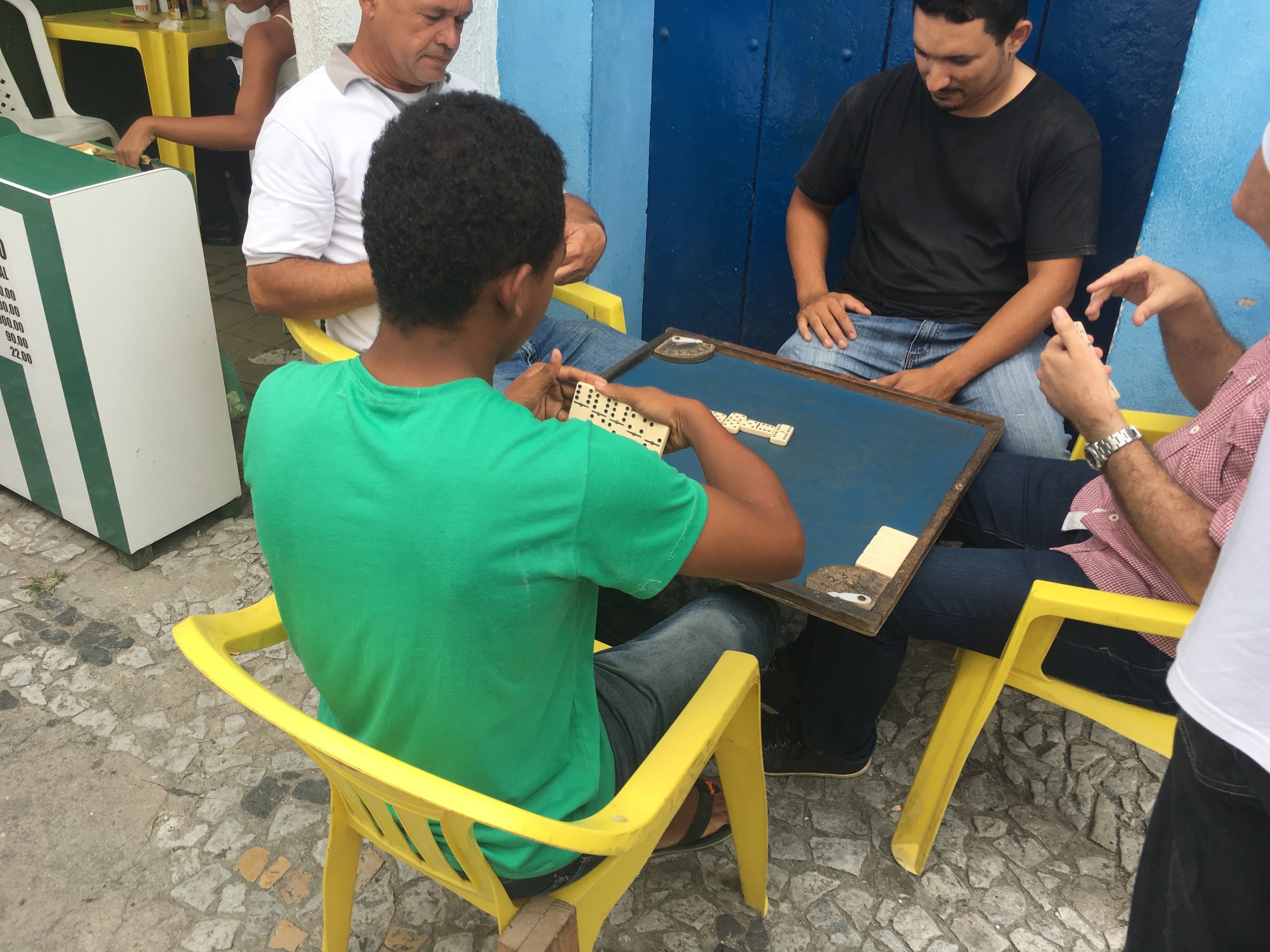 Locals play a game of dominos.