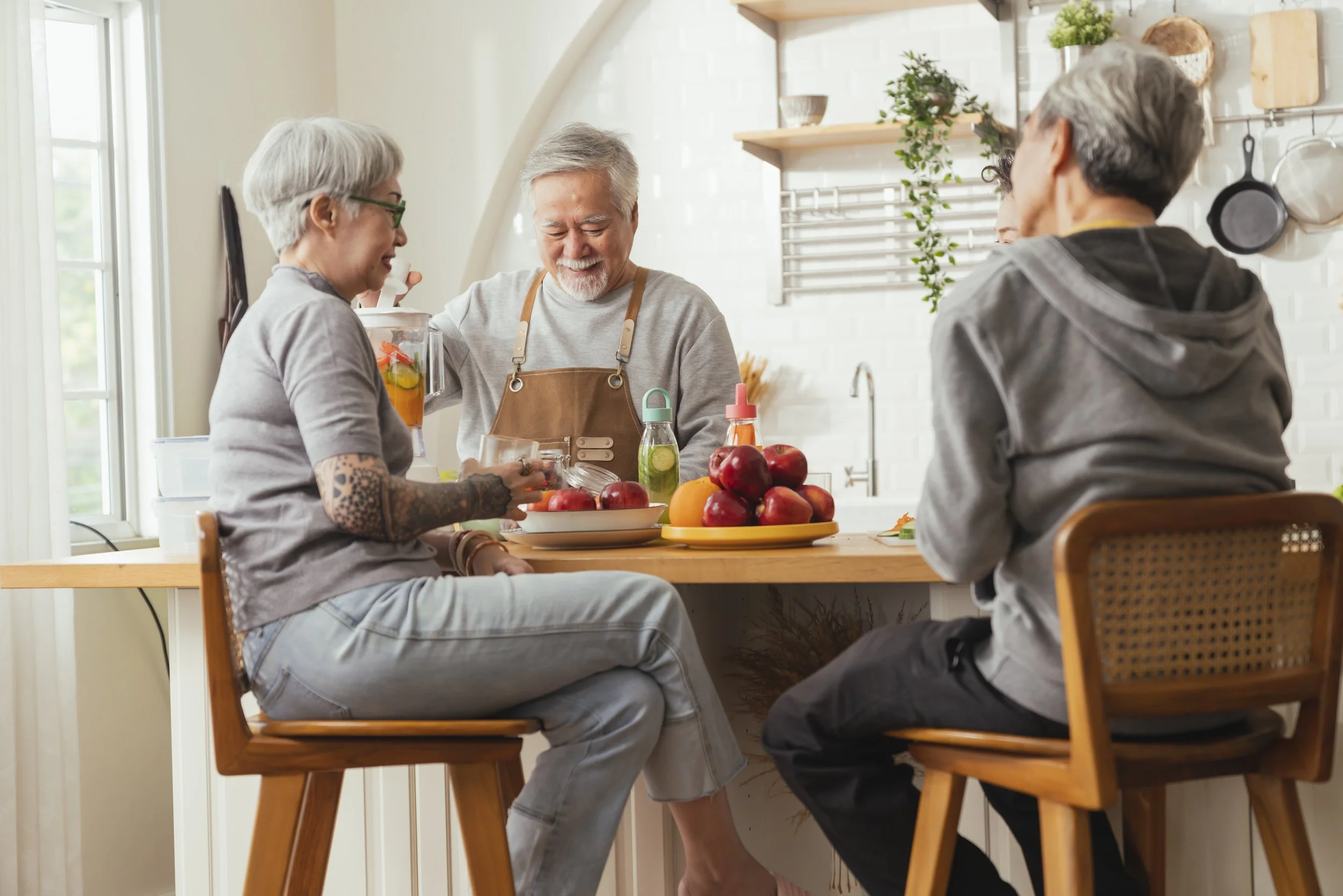 group-senior-friends-having-party-indoors-cooking-talking-positive-conversation-senior-daycareasian-senior-male-standing-kitchen-relaxing-home-while-eating-healthy-food-recipe.jpg