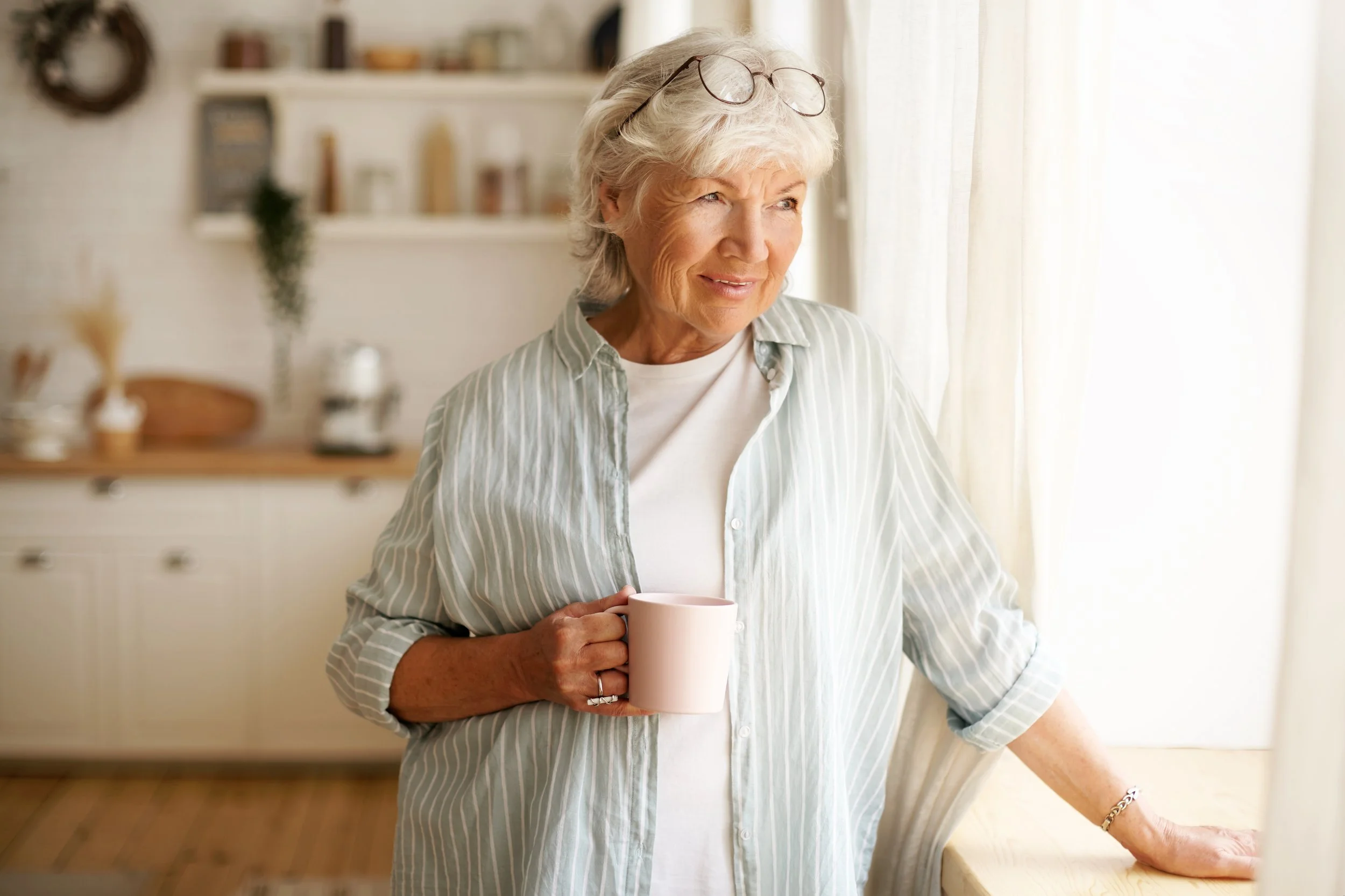 coziness-domesticity-leisure-concept-portrait-stylish-gray-haired-woman-with-round-spectacles-her-head-enjoying-morning-coffee-holding-mug-looking-outside-through-window-glass.jpg