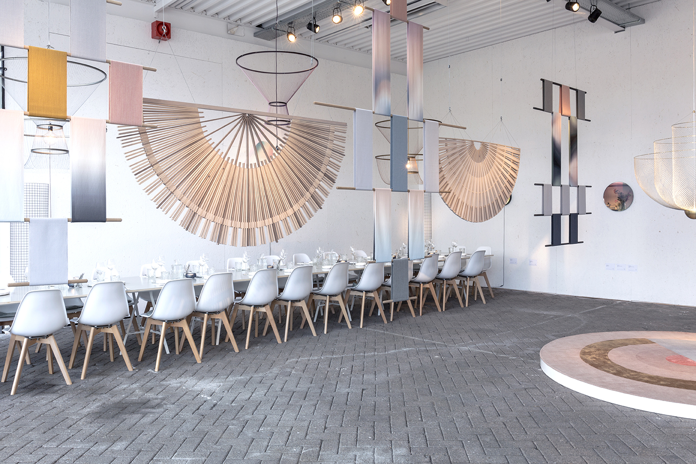 Circular Screens and Circadian Tapestries create a natural separation between the dining and exhibition areas