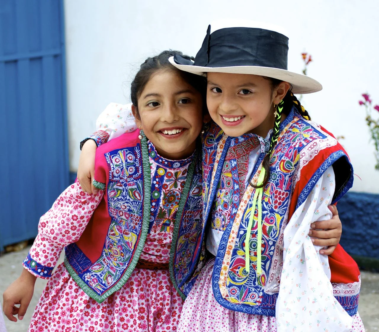 These brightly embroidered and embellished costumes, worn here by a pair of girls after a dance performance on Mother's Day, are part of the traditional dress of the Arequipa region of Peru (spring 2014, Cusco, Peru).