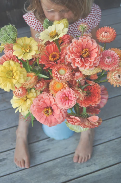 I remember when I was a child gathering daffodils, Lilly of the Valley, Queen Anne's lace and Black Eyed Susan's at my grandparents' farm as the seasons progressed. We'd make bouquets and fill vases. My grandmother had three distinct areas of her home where she cultivated flowers, her greenhouse which later on was expanded with a potting shed, her front porch which was enclosed in the wintertime and felt very much like a walled english garden or solarium and her rainforest garden. She also had a vegetable garden and various patches of flowers on the farm, but from what I recall she had a few distinct loves: orchids, lilies and hibiscus, each cultivated in a specific location. She tended these loves with great attention. Once when I was a child in the summer I remember laying in the rainforest garden just after the hanging orchids had been watered gazing up from a bed of moss as droplets fell on my face and I stared in wonderment at the tangle of hanging roots. She nurtured these plants with a singular devotion and when they were in bloom there was no greater beauty. I remember her moving through her greenhouse, transplanting and watering, on her knees amongst the zucchini, the delicious succulence of her raspberries. She spoke the language of flowers with an abandon and fidelity that few today herald. The natural world enchanted her from birds, to shells to flowers and she found many ways to dive deep into this enchantment. She was curious about the patterns and habits of our earths ecology, intrigued by the myriad ecosystems in our biosphere. 