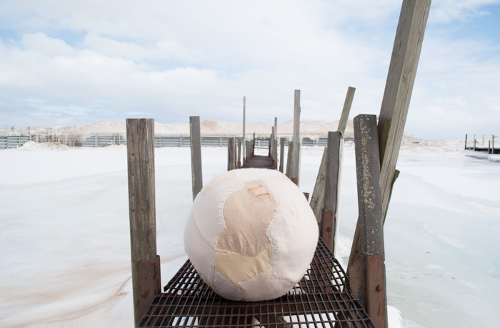 If it doesn't will we make mock snowballs for our children to play with and tell them stories about the good ole' days of igloos and ice skating, of snow men and angels? Will we endeavor to find joy in an earth deprived of her chance to sleep? How over tired she might become, her fields no longer dormant in winter. Given all of this potential I am offering up one mended snowball. Both, as an effort to repair the damage we have already done, to mend some minuscule aspect of our changing climate, but also to provide some vague memory for future generations of how it might have been, snow rolled on snow to form balls, balls for chucking at our buddies in the park, balls for building frosty beings to converse with and dream about. This giant snowball is made from my grandmother's vintage cashmere sweaters, worn thin and loved for their softness and warmth. They have been bundled and stitch together, a warm barrier in the cold, a symbol of winter's past and the warmth needed turned into winter's future and the search for snow flush with playfulness and joy. So get out there and love the cold while we have it. Embrace the ice and snow, but then of course, relish the warmth that is about to sweep across our doorsteps. I for one am pretty excited about it. **Okay so the extreme cold temperatures caused my poor mock snowball to deflate a bit. Please pardon her wrinkles. Have no fear, there are treatments for such things. 