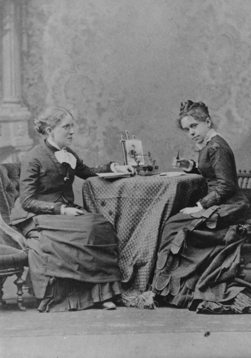 Historic Image of Frances Willard and her assistant Anna Gordon The Willard house, built by Willard’s father and continually occupied by the WCTU, has been mostly restored and captures a sense of what life might have been like within it’s walls when Willard resided there, all abustle with fervent women researching, writing, planning and distributing information. Unusually, there are a number of photographs of the interior of the house in its heyday capturing life in action, so the translation from organizing hub to house museum and back again was not so difficult to imagine. The rooms are small and the light limited which pushed my creativity and technical skills as a photographer. After making initial survey images of the house I went home and examined the images, meditated on them, and conjured my own version of the activities that might have gone on within this hive and how they relate to present day organizing. I then mapped out what I envisioned for each room of the house, making costumes and props and calling on friends to become actors in vignettes. At each shoot I told a story of the characters in the vignette and the particulars of what they were doing and why. I asked each woman to imagine that they were existing as a woman of the past, present and future, a bridge anchored in history. Although they wore the clothing of the past, they bore the wisdom and insight of today.