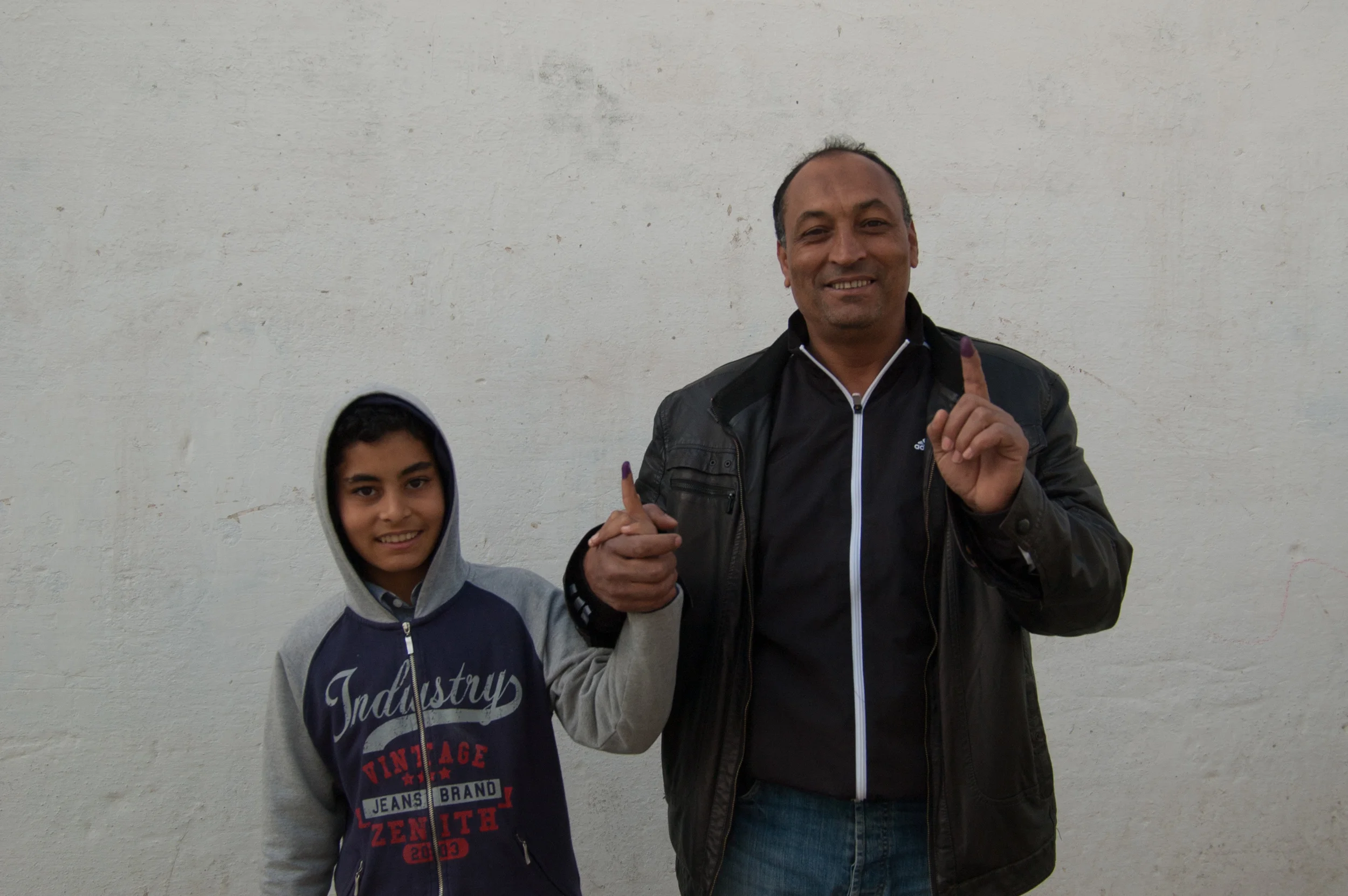 A man and his son after voting in the first round of Tunisia's presidential election. Kef, Tunisia. November 2014. 