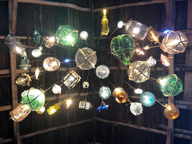 A close-up of our newly crafted antique wine bottle chandelier - unique and artistic touches abound at our farm!