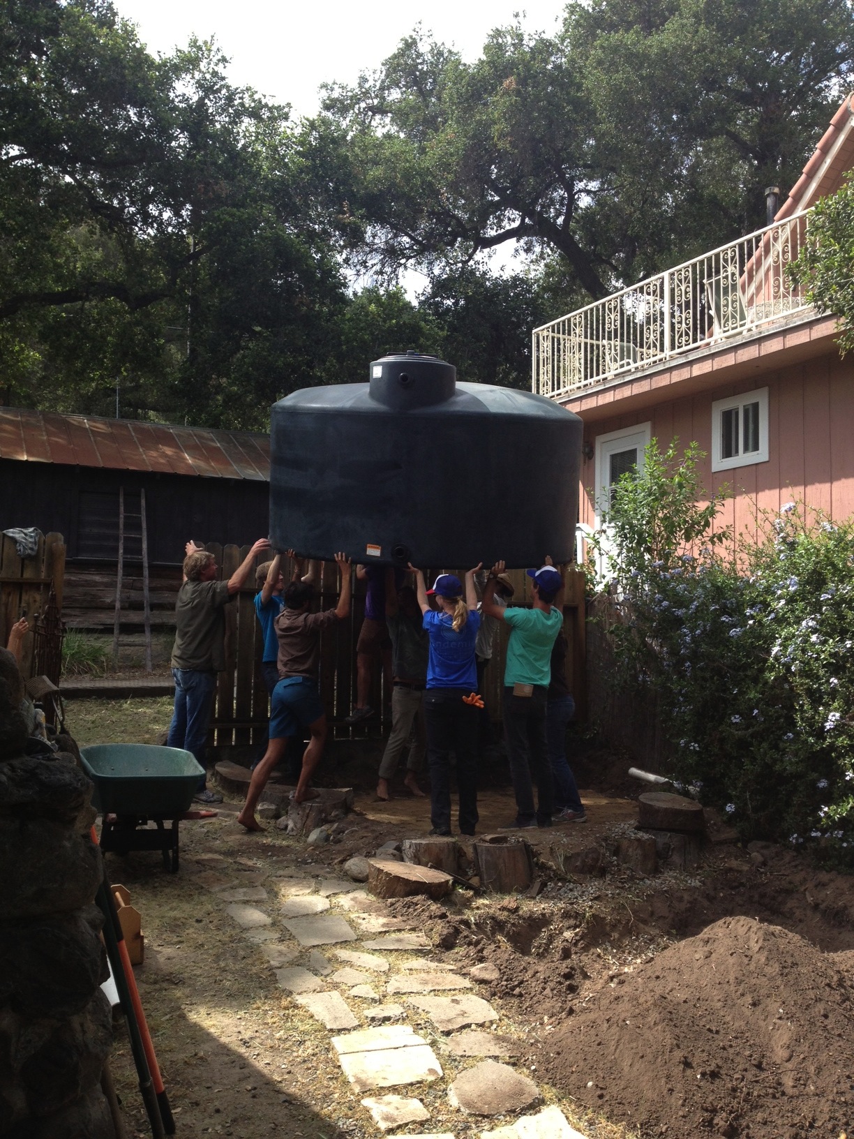 Moving a 1500 gallon tank over a fence doesn't always take a crew this big. But it sure felt good to have so many helpers!