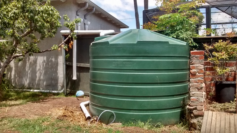 This 1320 gallon rainwater tank catches water from the neighbor's garage roof!
