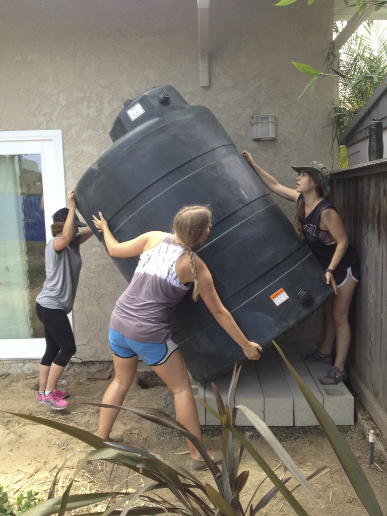 Teamwork makes installing this 500 gallon tank easy!