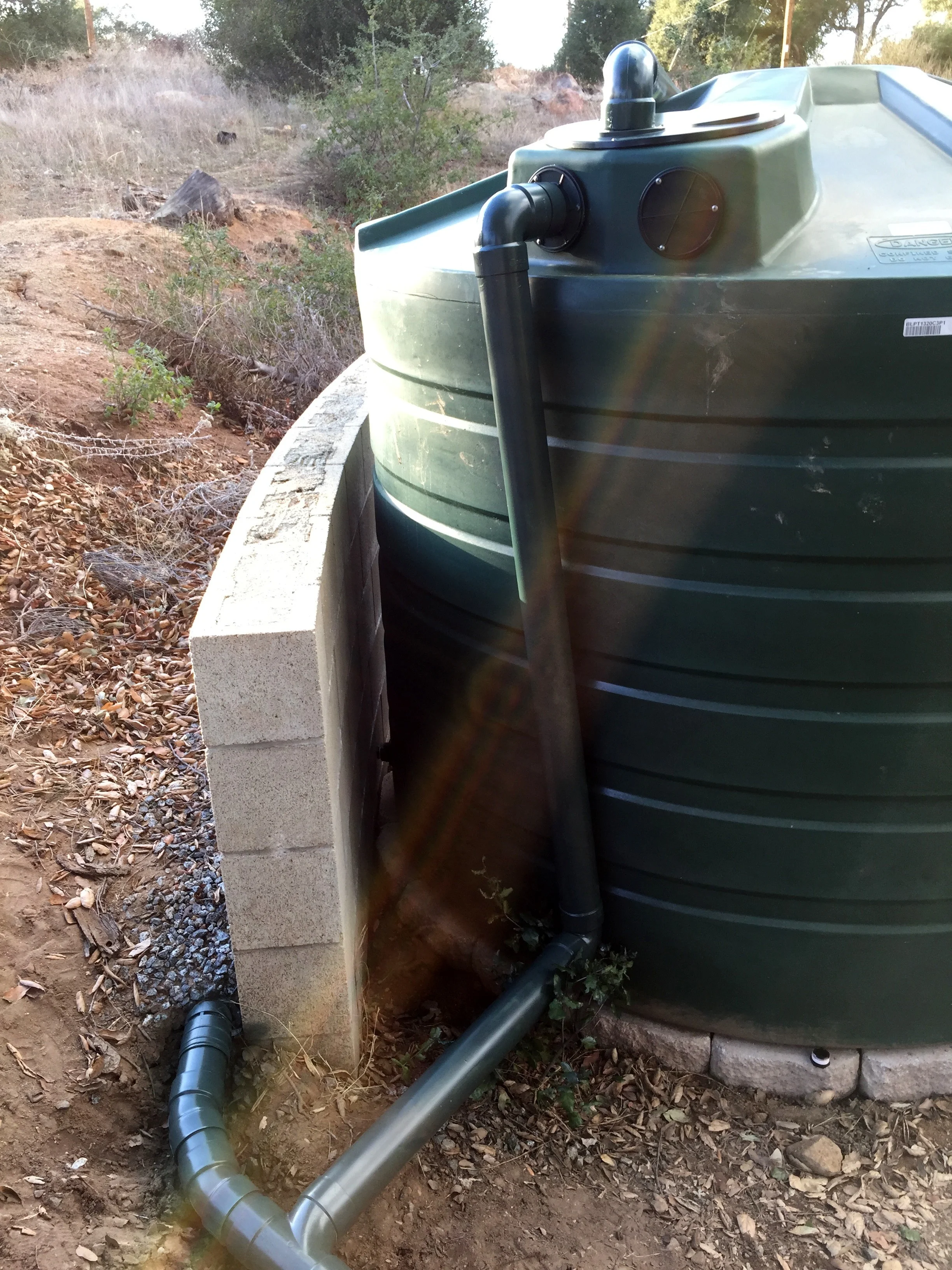 We combined the overflow from the rainwater tank with this wall drain and directed both to our raingarden