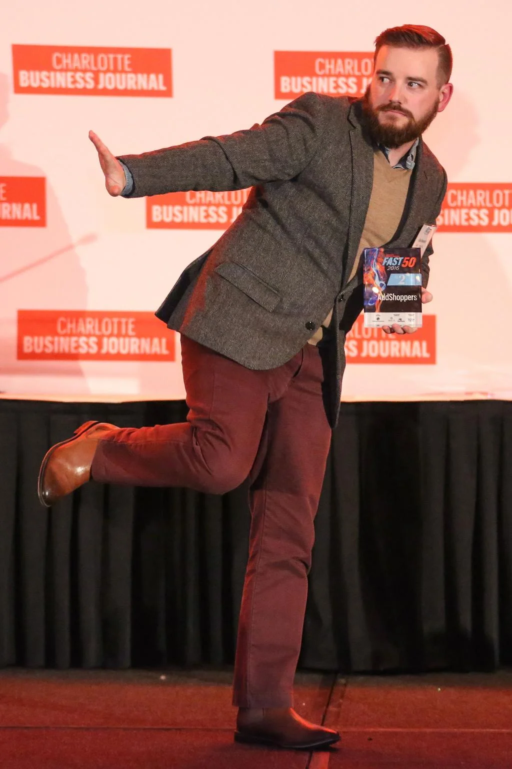 Kyle Bennett, Director + Client Success strikes a pose while accepting the company award. Photo: Melissa Key, Charlotte Business Journal