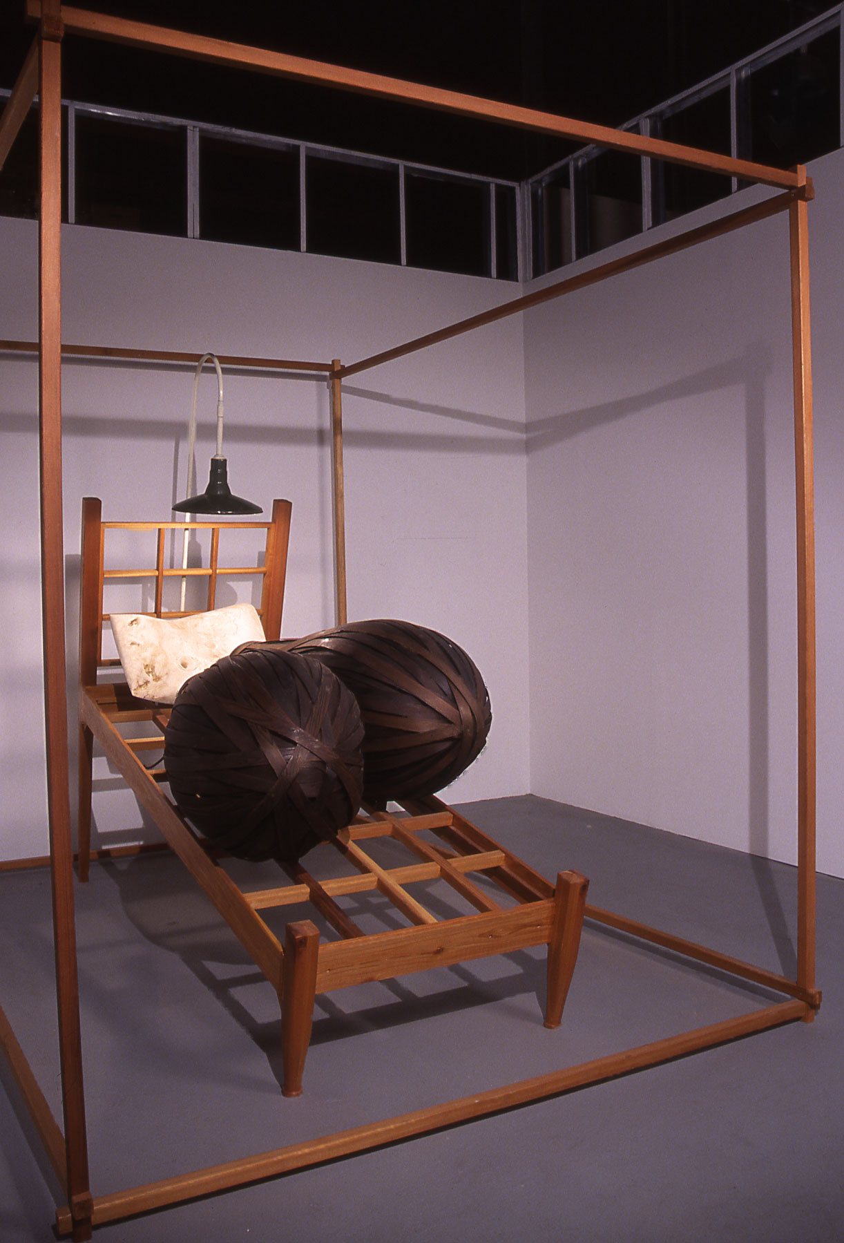 "Sleeping Double in a Single Bed", wood sculpture 8' h x 7' w x 8' d ; ebonized Cedar, carved Poplar, electric light; © Tom Gormally 