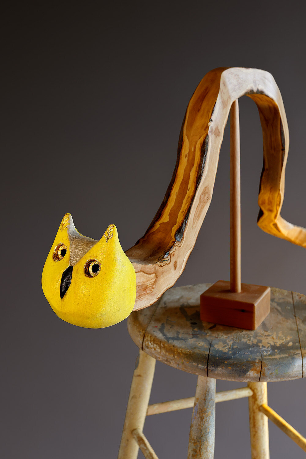 "Chimera with Stool and Rattle" (detail), 2021. 52” x 32” x 22”, wood, paint, gold leaf, LED light