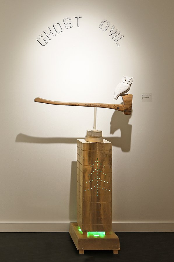 "Clear Cut with Ax, Owl, and Tree," 2022, 82" x 35" x 16", Wood, steel, plastic pipe, LED lights, corrugated lettering, 