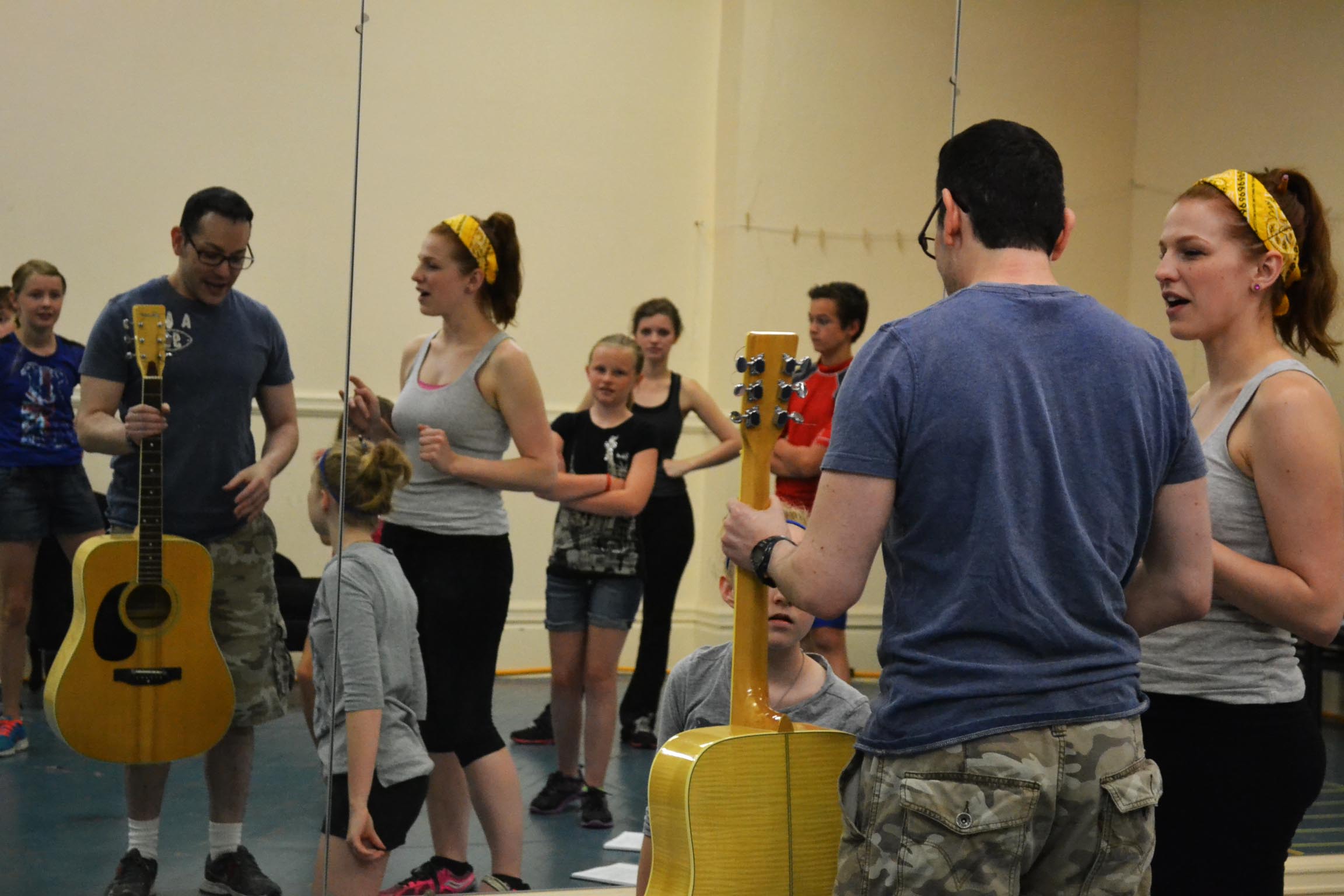 Director Joel Froomkin works with Lauren Lukacek (Maria) and the von Trapp children.