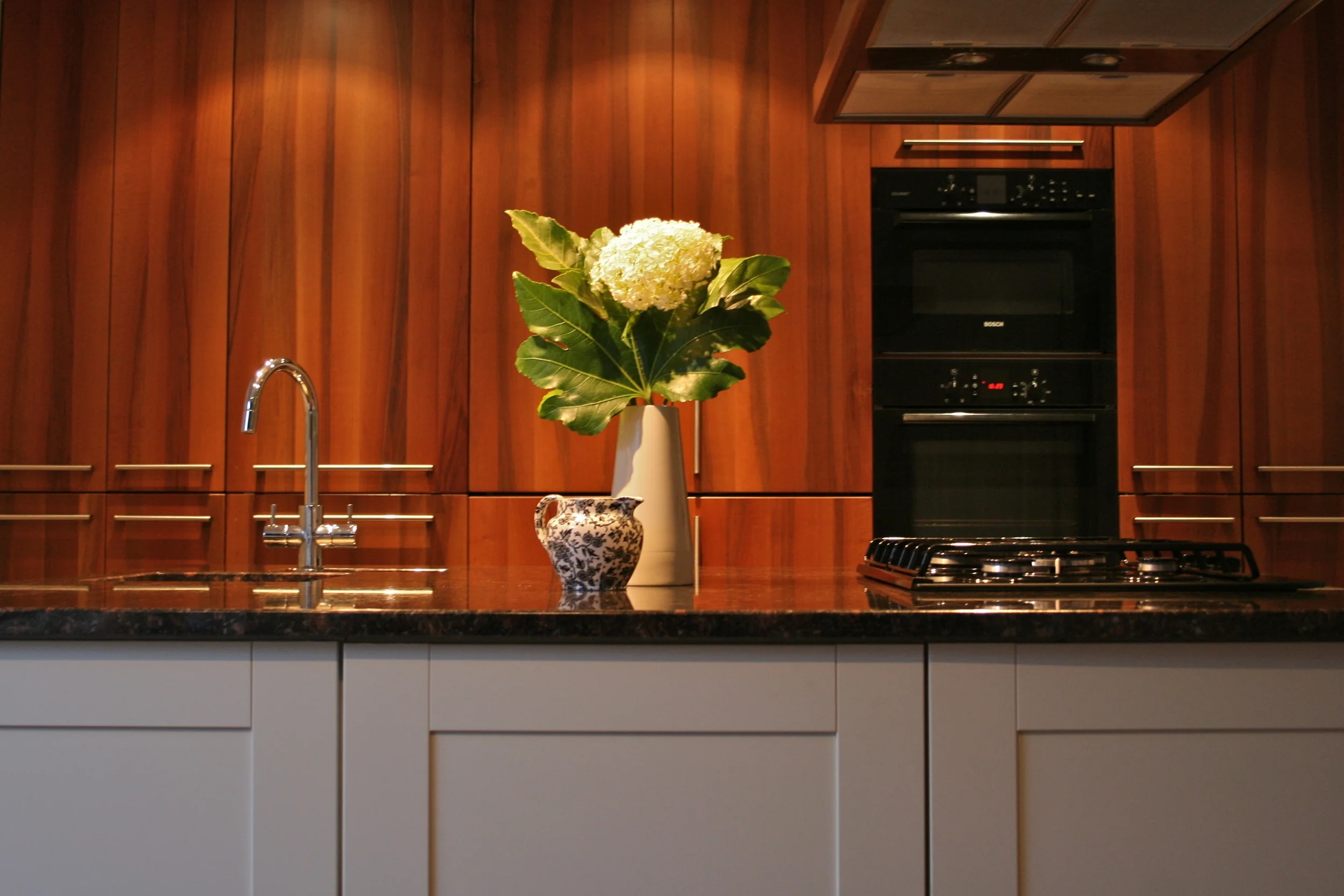 Kitchen Island and Wall of Walnut Cupboards | www.interiorsmatter.com