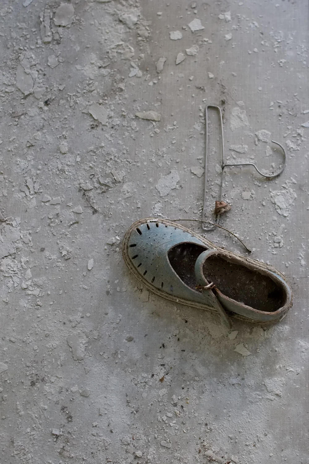Child's shoe and very small clothes hanger.