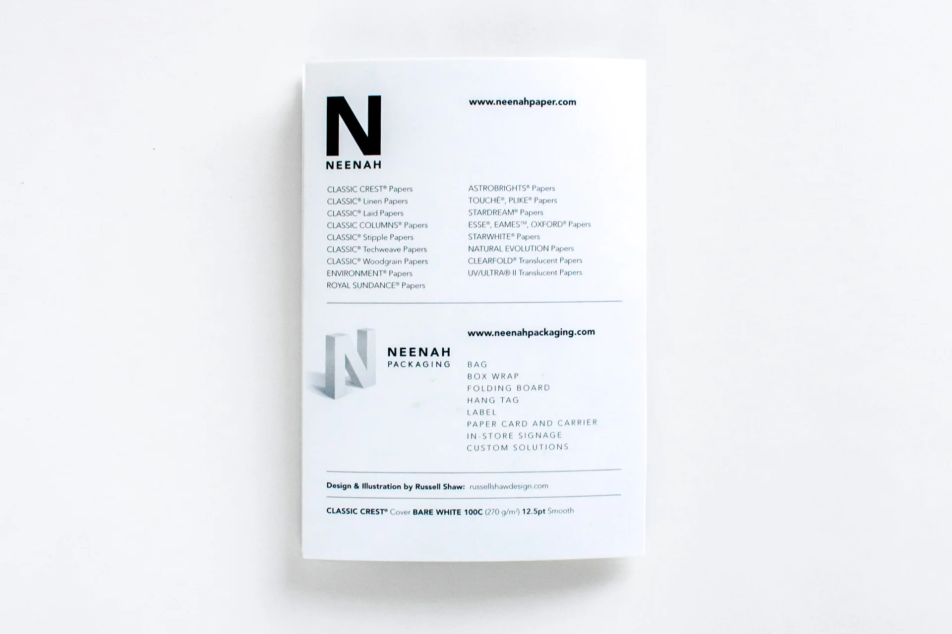 Back cover design of the Neenah Paper Presents Boston HOW Design Live 2018 conference promotional materials shows the full Neenah and Neenah Packaging product listing and credits Design and Illustration by Russell Shaw, with the paper Spec Classic Crest Cover Bare White 100C 12.5pt Smooth.