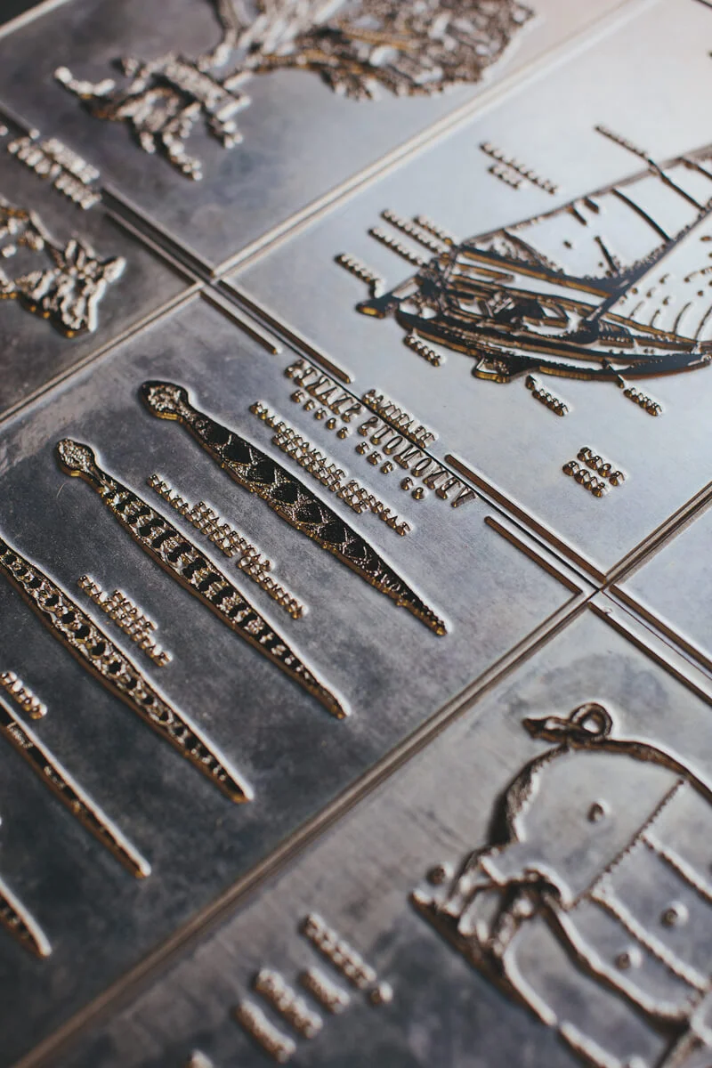 The original letterpress plates made out of metal stacked side by side for the Bearings letterpress infographic series with the focus on the types of snakes of the south print.