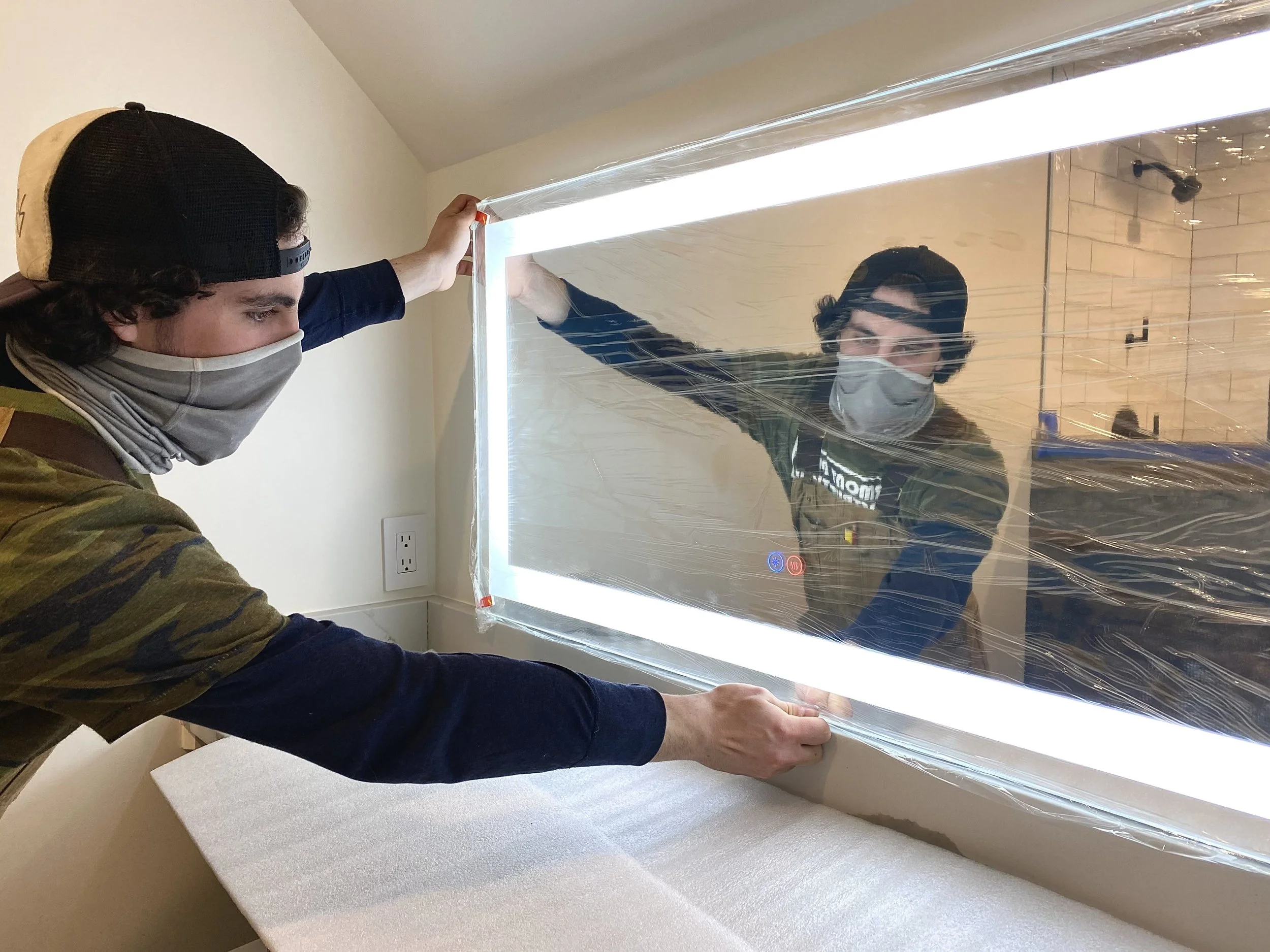 Morgan installing backlit mirror.jpg