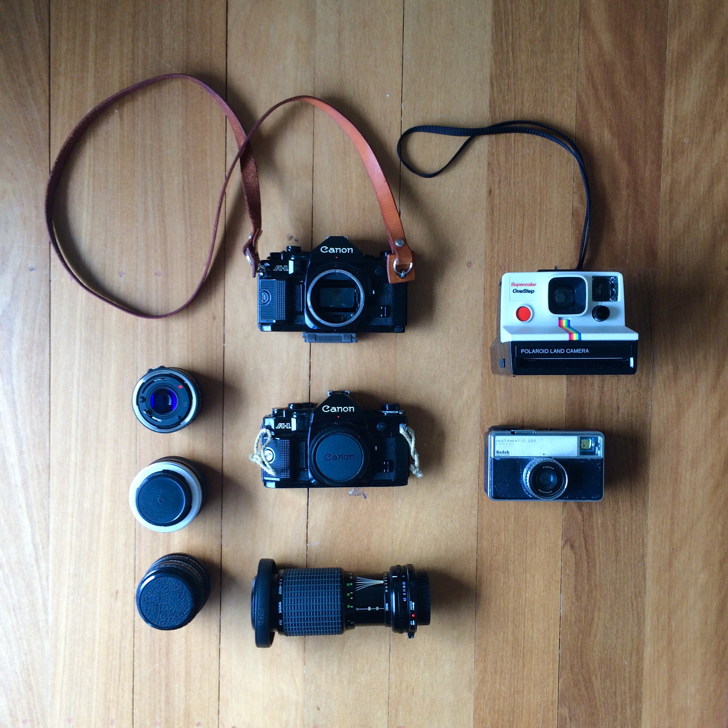 "Well I suppose you want the accessory kit?" Camera: 2x Canon A1 bodies (including 1x handmade leather camera strap by Chocolate Brownie Leather (Aussie made) highly recommended), Polaroid OneStep Color, Kodak Instamatic 233 Lenses (Canon A1- FD mount: Top to bottom - Sigma 28mm f/1.8, Vivitar Macro adaptor, Canon 50mm f/1.8, Sigma 70-210mm f/4.5 - f/6.3 (probably).