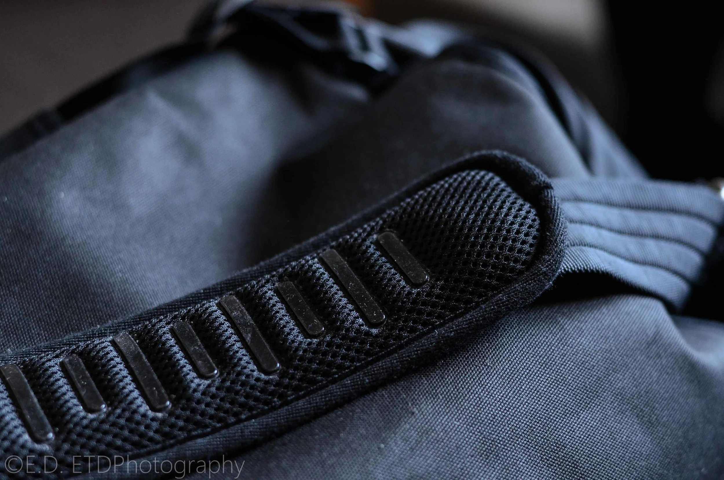 The thick strap has little rubber feet to keep the strap from slipping off your shoulder.