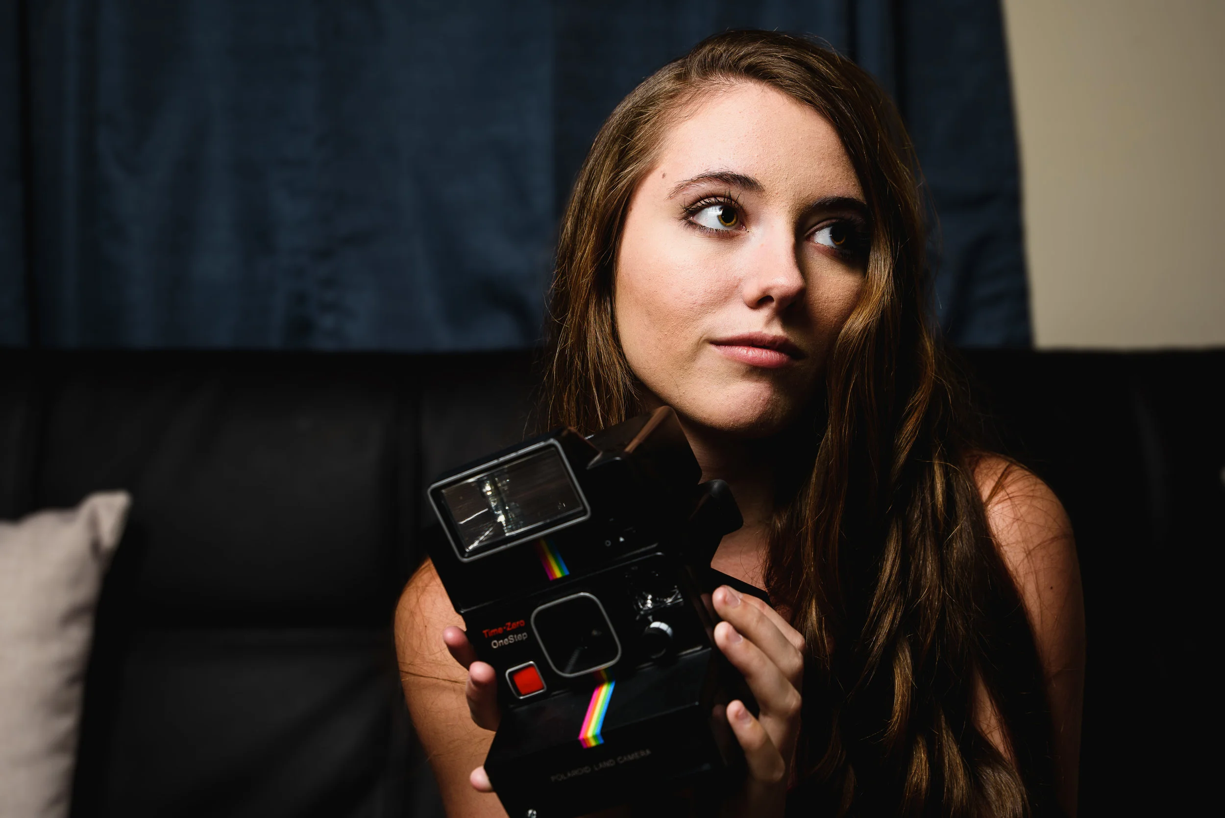 Nikon D750 Tamron 24-70 f/2.8 G2 @ 45mm 1/125s f/5.6 ISO 100 - Portrait of a photographer with a Polaroid one-step instant camera.