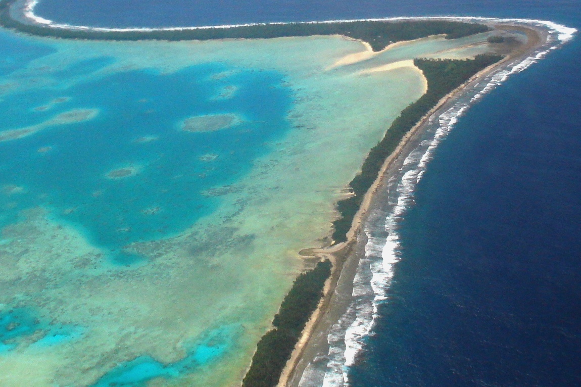 Aerial view of Tuvalu’s capital, Funafuti, 2011. Tuvalu is a remote country of low lying atolls, making it vulnerable to climate change. Photo Credit: Lily-Anne Homasi/DFAT (cc-by-2.0)