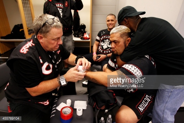 455769104-mark-hunt-is-hugged-by-burt-watson-backstage-gettyimages.jpg