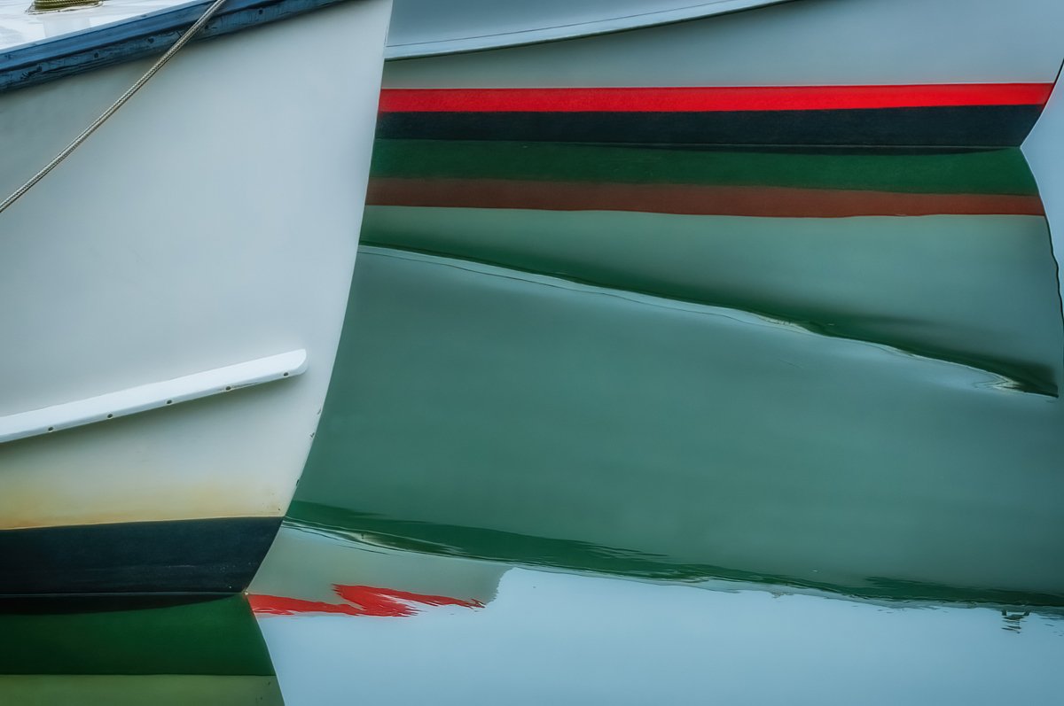 Reflection of lobster boat bows
