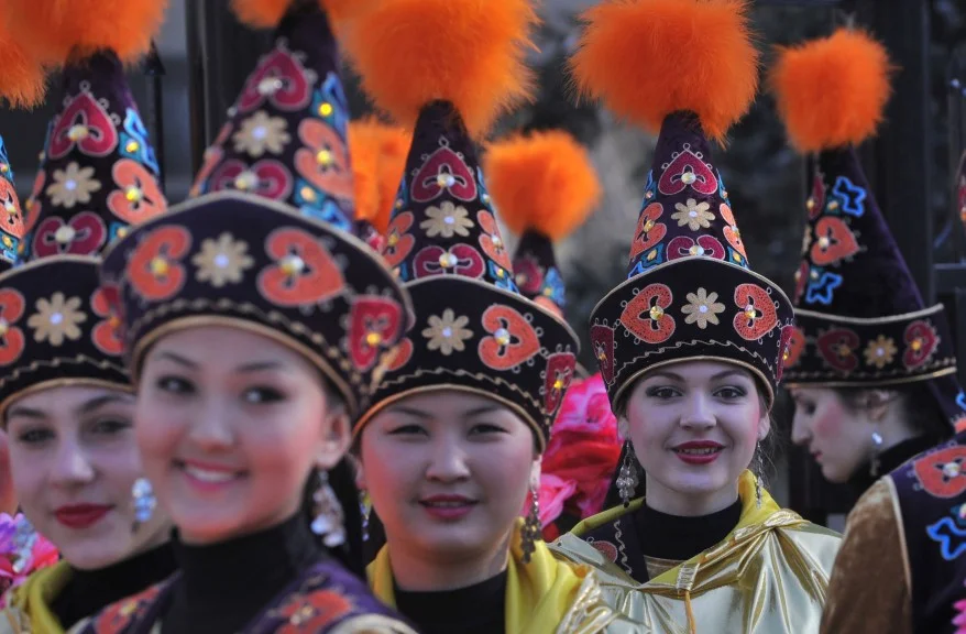 Women of Kyrgyzstan of different ethnicities in traditional Kyrgyz dresses and hats