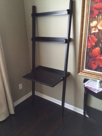 Pair of Crate and Barrel Leaning Shelves $60 - One is a standard 5 shelf and the other has this small desk/shelf. 