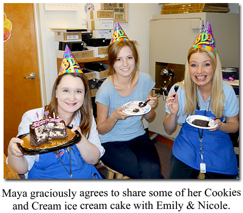 Cake-eating Southgate Coins employees Maya Jones and Nicole Hoff take a break from buying and selling rare coins and gold and silver bullion