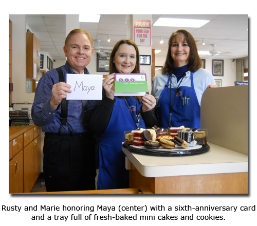 Southgate Coins owners Rusty and Marie Goe honor manager Maya Jones on her sixth anniversary with the Reno coin shop