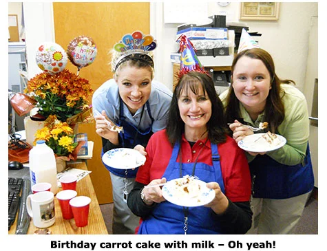 Nicole Hoff and Maya Roberts present Marie Goe with carrot cake