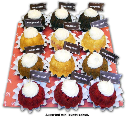 Southgate Coins employee Nicole Hoff receives mini-bundt cakes for her 2 year anniversary