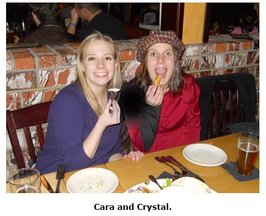 Southgate Coins staffers Crystal and Cara stuff their face during the Christmas dinner