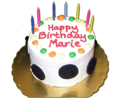 Southgate Coins owner Marie Goe receives a colorful cake on her birthday