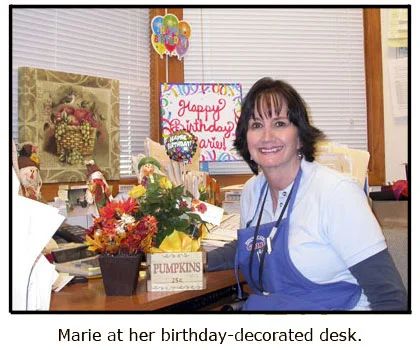 Marie enjoys her autumn-themed birthday presents at her desk at Southgate Coins
