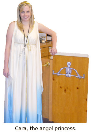 Cara dresses as an angel princess for Halloween at the coin shop