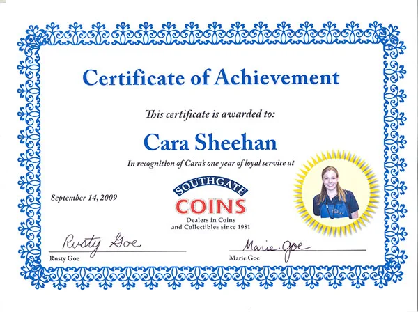 Cara receives a certificate for her one-year anniversary at Southgate Coins