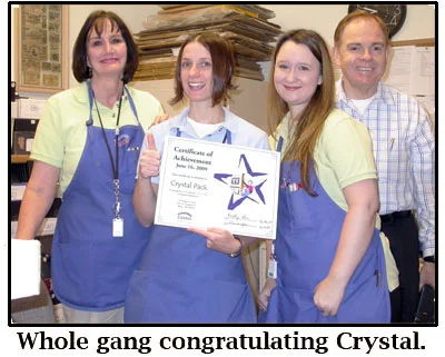 Crystal gets cake and a certificate on her one-year anniversary at the coin shop