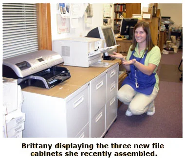 Britanny showing off her newly assembled file cabinets