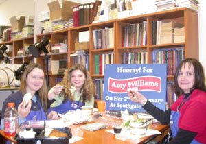 Maya, Marie, and Amy pose with lunch on Amy’s anniversary with the coin shop